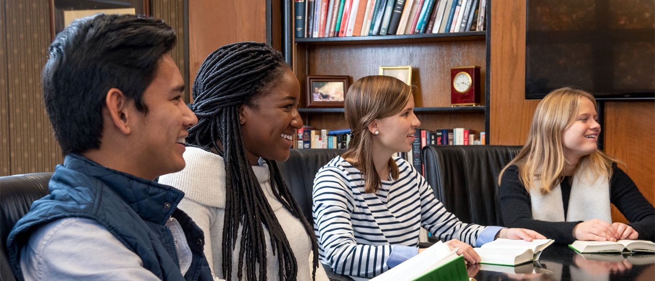 conference-table-honors-students Honors students sitting at conference table