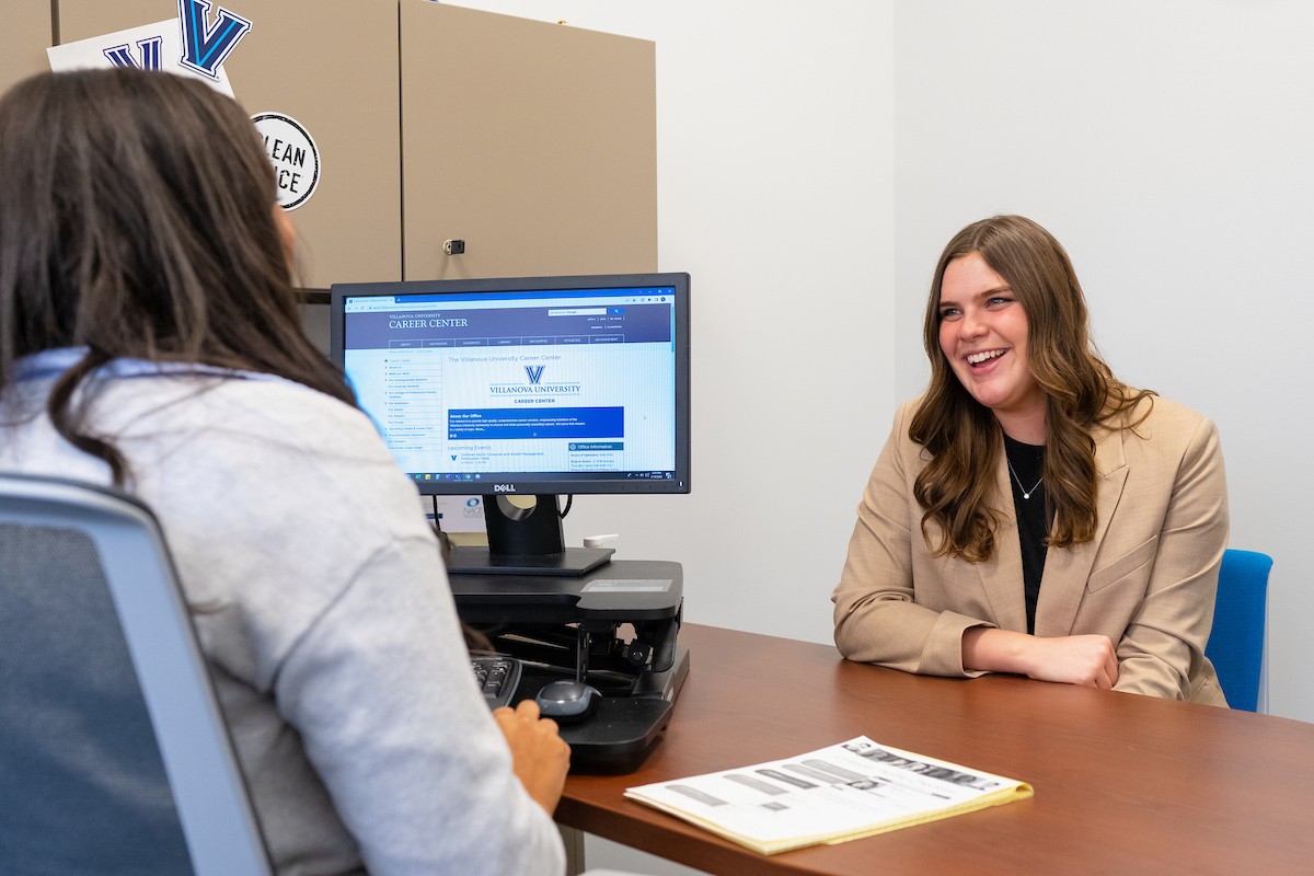 Student speaking to a staff member in an office in the Career Center. Student speaking to a staff member in an office in the Career Center.