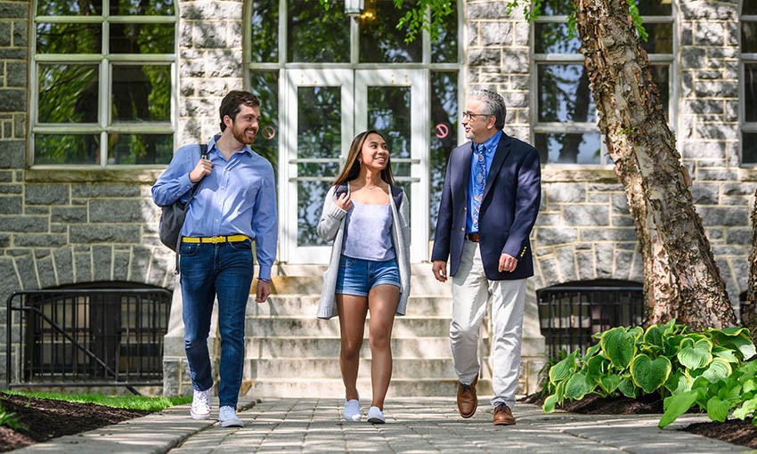 professor-students-outside-tolentine Faculty member walking with two Villanova students outside Tolentine Hall.
